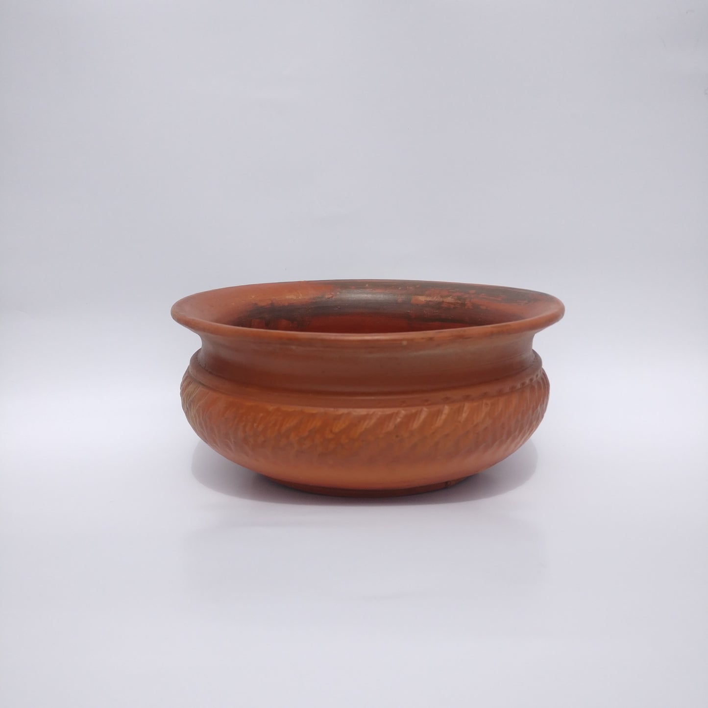 A dark orange clay pot